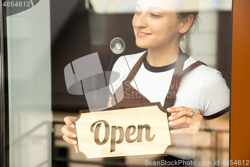 Image of Open sign on the glass of street cafe or restaurant