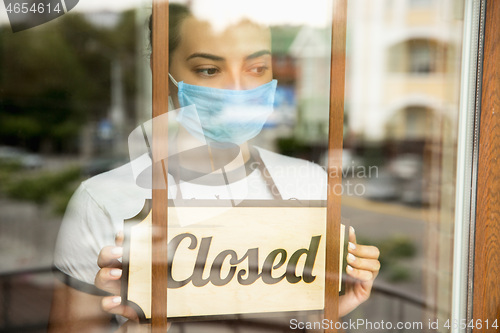 Image of Closed sign on the glass of street cafe or restaurant