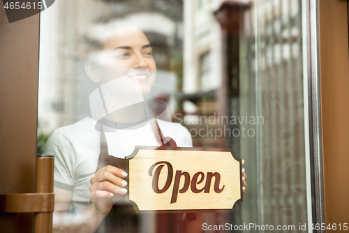 Image of Open sign on the glass of street cafe or restaurant