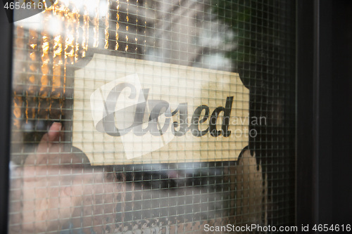 Image of Closed sign on the glass of street cafe or restaurant