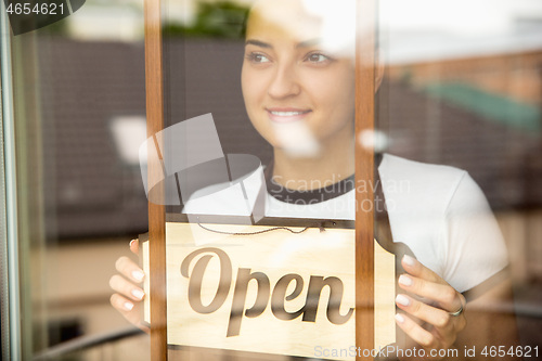 Image of Open sign on the glass of street cafe or restaurant