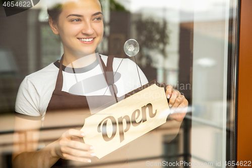 Image of Open sign on the glass of street cafe or restaurant