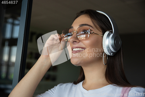 Image of Young woman waiting for departure in airport, traveler with small baggage, influencer\'s lifestyle