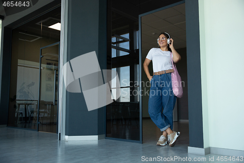 Image of Young woman waiting for departure in airport, traveler with small baggage, influencer\'s lifestyle