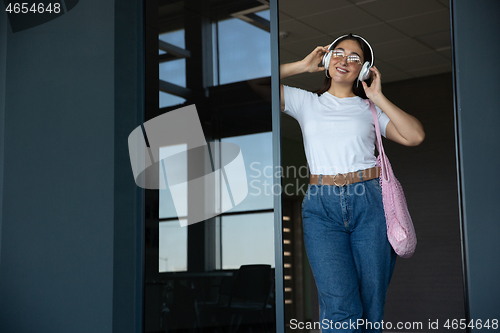 Image of Young woman waiting for departure in airport, traveler with small baggage, influencer\'s lifestyle