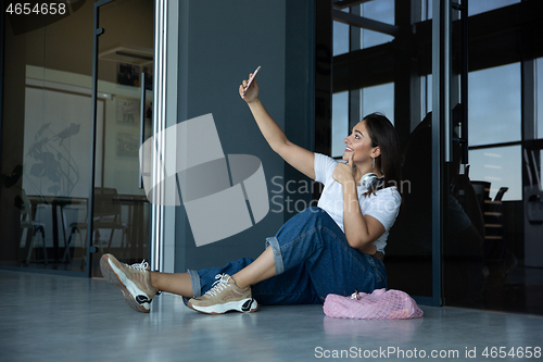 Image of Young woman waiting for departure in airport, traveler with small baggage, influencer\'s lifestyle