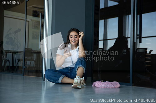 Image of Young woman waiting for departure in airport, traveler with small baggage, influencer\'s lifestyle