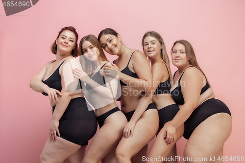 Image of Portrait of beautiful young women with different shapes posing on pink background