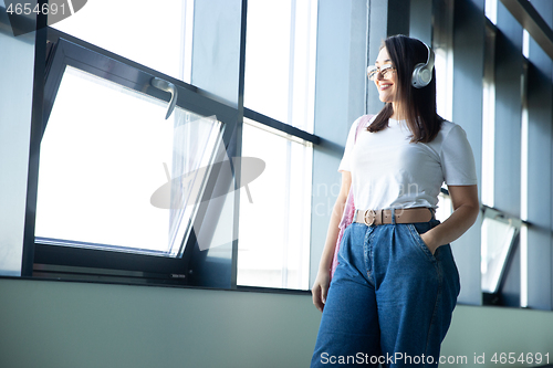 Image of Young woman waiting for departure in airport, traveler with small baggage, influencer\'s lifestyle