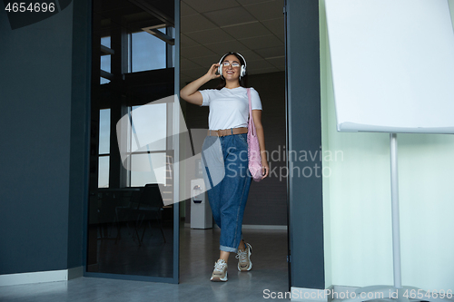 Image of Young woman waiting for departure in airport, traveler with small baggage, influencer\'s lifestyle