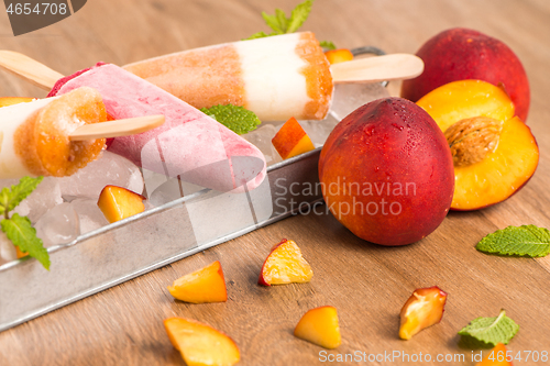 Image of Homemade raspberries and peach popsicles