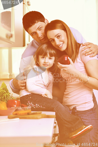 Image of happy young family in kitchen