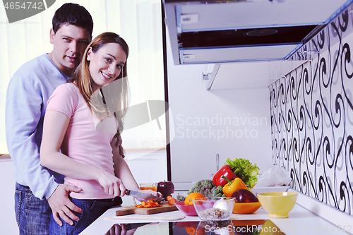 Image of couple have fun and preparing healthy food in kitchen