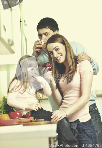 Image of happy young family in kitchen