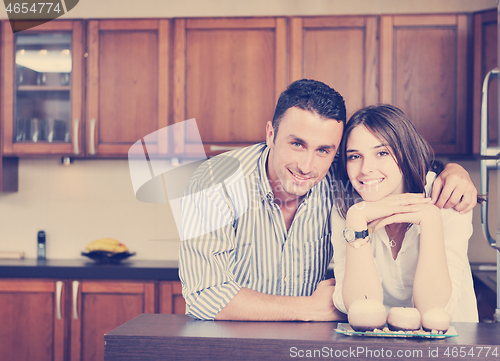 Image of happy young couple have fun in modern kitchen