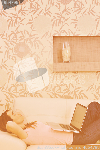 Image of woman relaxing and working at home