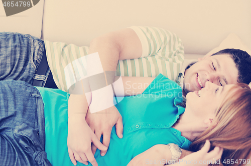 Image of couple relax at home on sofa