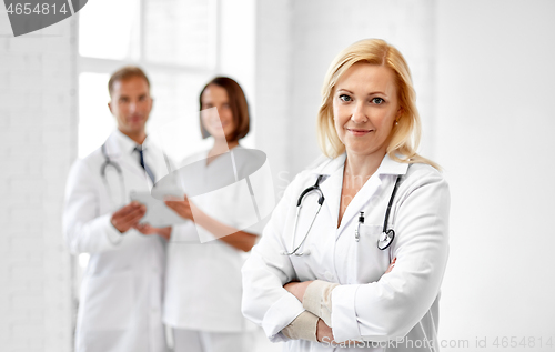 Image of smiling doctor in white coat at hospital