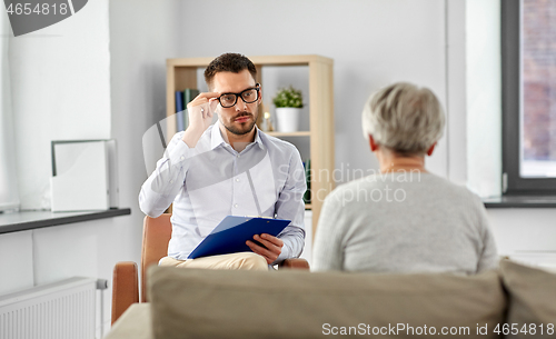Image of psychologist listening to senior woman patient