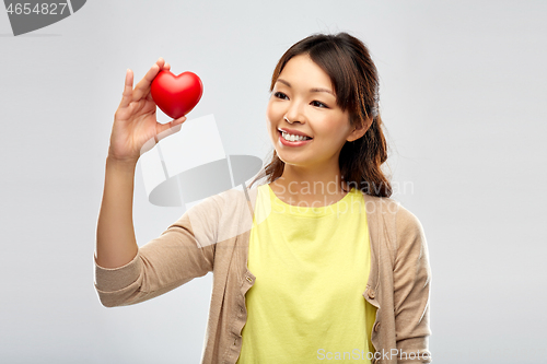 Image of happy asian woman holding red heart