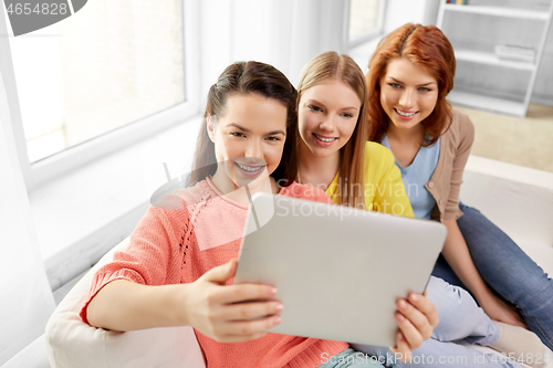 Image of teenage girls with tablet pc taking selfie at home