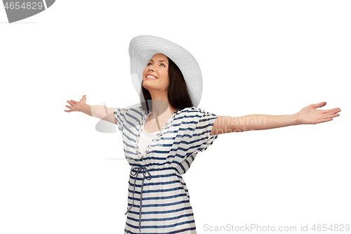 Image of young woman in striped tunic and sun hat