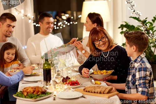 Image of happy family having dinner party at home