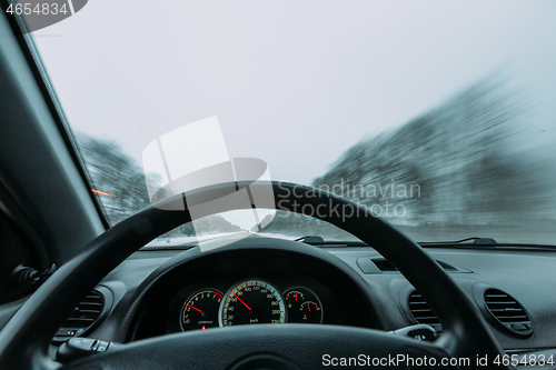 Image of Riding behind the wheel of a car in winter