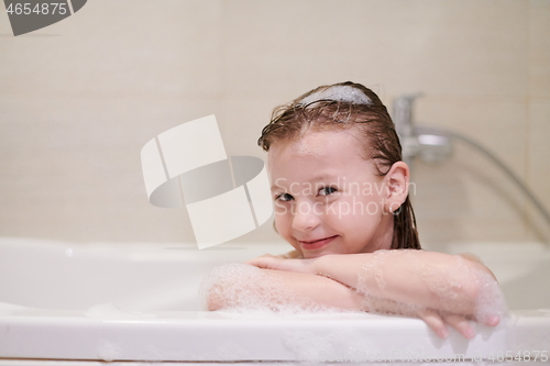 Image of little girl in bath playing with soap foam