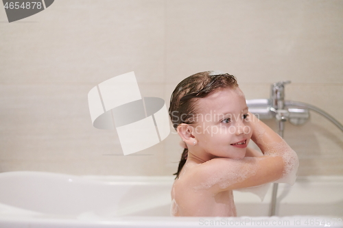 Image of little girl in bath playing with soap foam