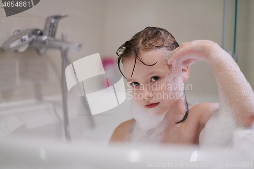 Image of little girl in bath playing with soap foam