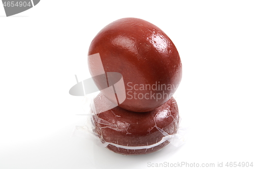 Image of Smoked brown Cheese wheel isolated on white background