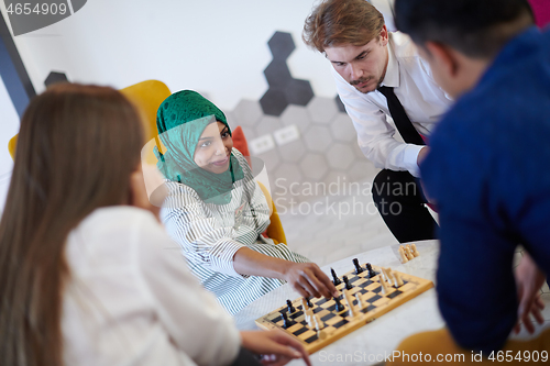 Image of multiethnic group of business people playing chess