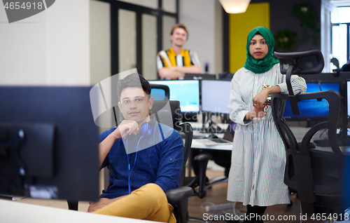 Image of Multiethnic startup business team with Arabian woman