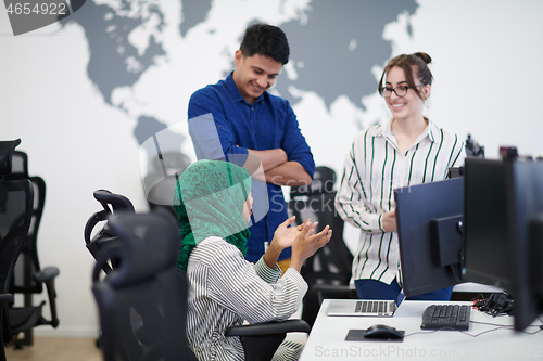 Image of Multiethnic startup business team with Arabian woman