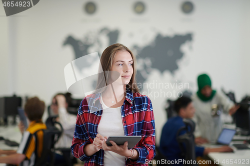 Image of portrait of businesswoman holding tablet computer