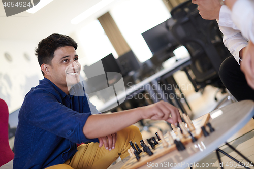 Image of multiethnic group of business people playing chess