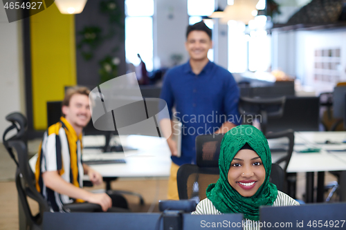 Image of Multiethnic startup business team with Arabian woman