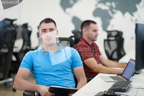 Image of two male software developers working on computer