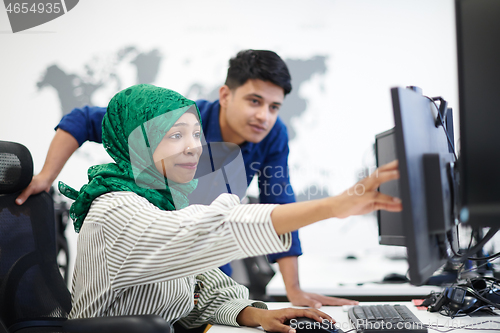 Image of Multiethnic startup business team with Arabian woman