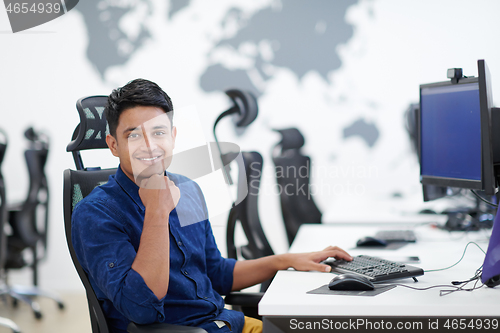 Image of casual indian business man working on desktop computer