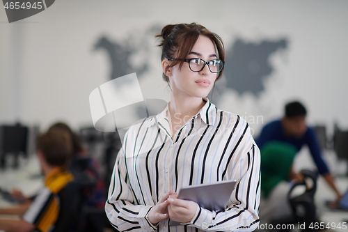 Image of portrait of businesswoman holding tablet computer