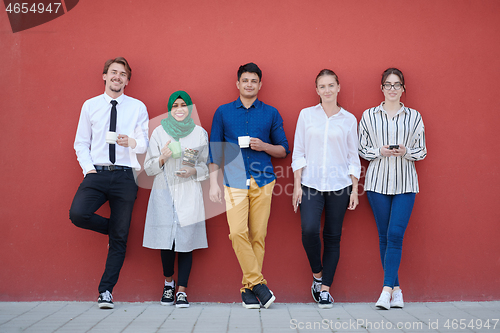 Image of multiethnic group of casual business people during coffee break