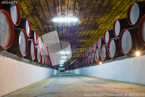 Image of Underground wine wooden barrels stack
