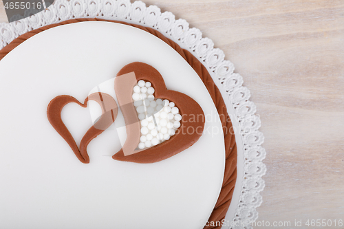 Image of valentine love cake with hearts on wooden background