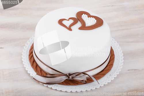 Image of valentine love cake with hearts on wooden background