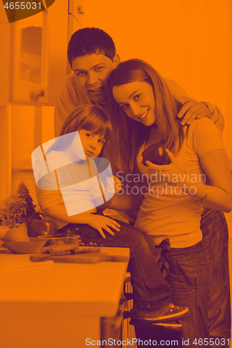 Image of happy young family in kitchen