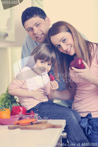 Image of happy young family in kitchen