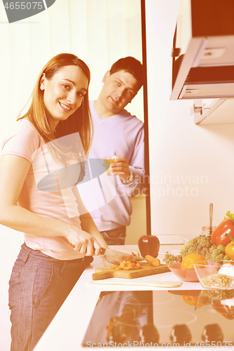 Image of couple have fun and preparing healthy food in kitchen