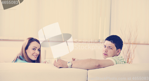 Image of couple relaxing at home